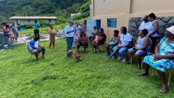 Opposition Leader Godwin Friday, standing, chats with North Windward residents during a visit to the district Wednesday amidst the effusive eruption of La Soufriere. (Photo: Bryan Alexander)