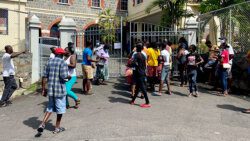There was an observable increase in the number of masks being worn in Kingstown on Monday, including among these persons waiting to access services at VINLEC. (iWN photo)