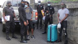 Jamaican Linford George Robinson, right, and Vincentian Erasto Nero, left, arrive under heavy police escort at the Serious Offences Court on Thursday. (iWN photo)