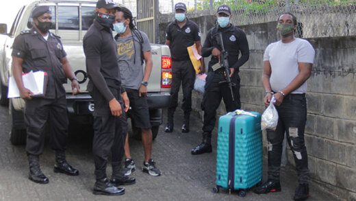 Jamaican Linford George Robinson, right, and Vincentian Erasto Nero, left, arrive under heavy police escort at the Serious Offences Court on Thursday. (iWN photo)