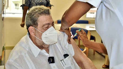 Prime Minister Ralph Gonsalves receives a COVID-19 jab from a nurse, who is not wearing gloves. (Photo: Lance Neverson/Facebook)
