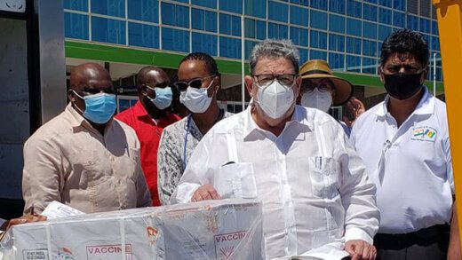 Prime Minister Ralph Gonsalves, center, Health Minister St. Clair "Jimmy" Prince, far left, and Chief Medical Officer, Dr. Simone Keizer-Beache 3rd left, at Argyle International Airport on Monday when the vaccines arrived. (Photo: Argyle International Airport Inc.)