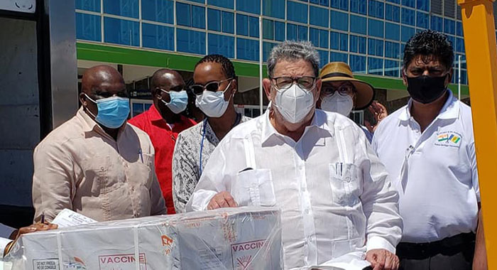 Prime Minister Ralph Gonsalves, center, Health Minister St. Clair "Jimmy" Prince, far left, and Chief Medical Officer, Dr. Simone Keizer-Beache 3rd left, at Argyle International Airport on Monday when the vaccines arrived. (Photo: Argyle International Airport Inc.)