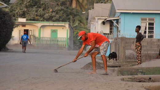 A man heaps up volcanic ash in Barrouallie, on Thursday. (iWN photo)