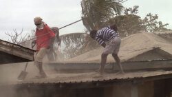 Men clean volcanic ash from the roof of a house in Owia last Week Wednesday, April 21, 2021. (iWN photo)