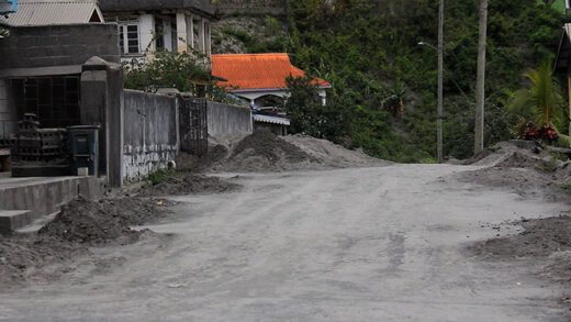 Heaps of volcanic ash along the roadside in the Orange Zone town of Chateaubelair on Monday. (iWN photo)