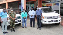 From left: head of the Traffic Branch, superintendent of Police Kenneth John, Commissioner of Police Colin John, Director of NEMO, Michelle Forbes, Managing Director of Coreas Hazells, Joel Providence, and Permanent Secretary in the Ministry of National Security, Hudson Nedd pose near the two vehicles at Saturday’s event. (iWN photo)