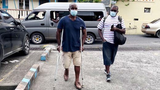 Cornelius JOhn on crutches