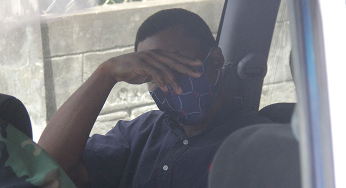 Aneil Hayzelwood sits in a police vehicle awaiting transportation to prison on Tuesday. (iWN photo)