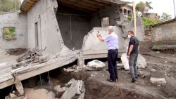 Volkan Bozkir, president of the 75th United Nations General Assembly, photographs a house in Sandy Bay destroyed by mudflows after the eruption. (Photo: API)
