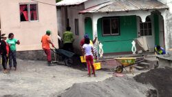 Residents of Owia remove volcanic ash from a home on Aug. 13, 2021. (iWN photo)