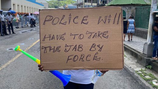 A placard outside Parliament Parliament, on Aug. 5. Police officers will soon have to be vaccinated to remain in their jobs. (iWN Photo)