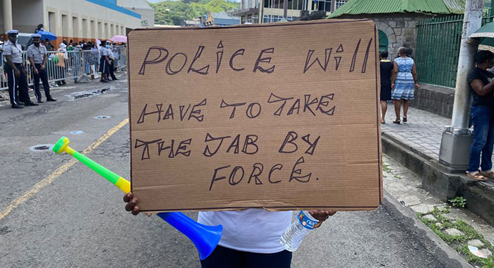 A placard outside Parliament Parliament, on Aug. 5. Police officers will soon have to be vaccinated to remain in their jobs. (iWN Photo)