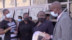 Lawyer Kay Bacchus-Baptiste, 2nd from right, her clients, Carly John, right, and Cherry-Ann Caine, 2nd left, along with Senator Shevorn John, Mr. John's wife, outside the Kingstown Magistrate's Court on Tuesday. (iWN photo)