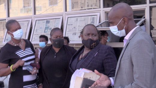 Lawyer Kay Bacchus-Baptiste, 2nd from right, her clients, Carly John, right, and Cherry-Ann Caine, 2nd left, along with Senator Shevorn John, Mr. John's wife, outside the Kingstown Magistrate's Court on Tuesday. (iWN photo)