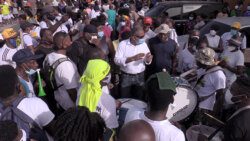 Opposition Leader Godwin Friday, centre, among drummers and other protesters after the drums were returned. (iWN photo)