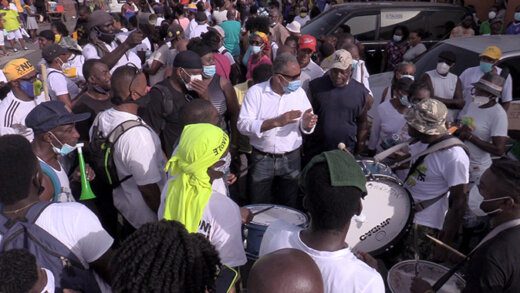 Opposition Leader Godwin Friday, centre, among drummers and other protesters after the drums were returned. (iWN photo)