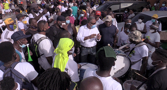 Opposition Leader Godwin Friday, centre, among drummers and other protesters after the drums were returned. (iWN photo)
