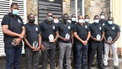 The 10 officers pose with Commissioner of Police, Colin John.