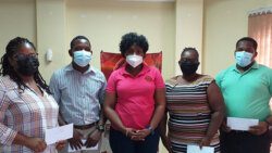 Four of the recipients and the Deputy CEO/Loans Manager, Nekeisha Adams (centre) of SVGTCCU Ltd.