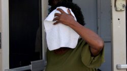 Naomi Nero uses a rag to hide her face as she leaves the Kingstown Magistrate's Court on Monday, Dec. 6, 2021. (iWN photo)