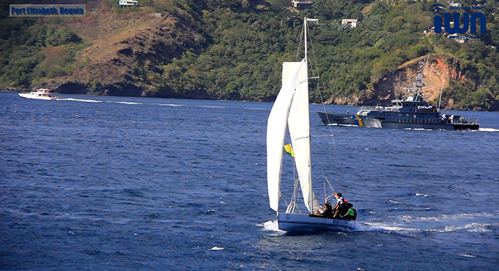 Bequia Youth Sailors used their seafaring skills  and a traditional 28-footer Bequia sailboat to pay tribute to Sir James Mitchell on the day of his funeral last Saturday, Dec. 18. 2021. (iWN photo)