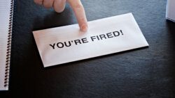 finger pointing at letter on office desk