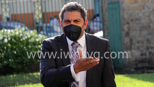 Minister of Finance Camillo Gonsalves gestures to a parliamentary colleague as he arrives at Parliament on Monday afternoon. (iWN photo)