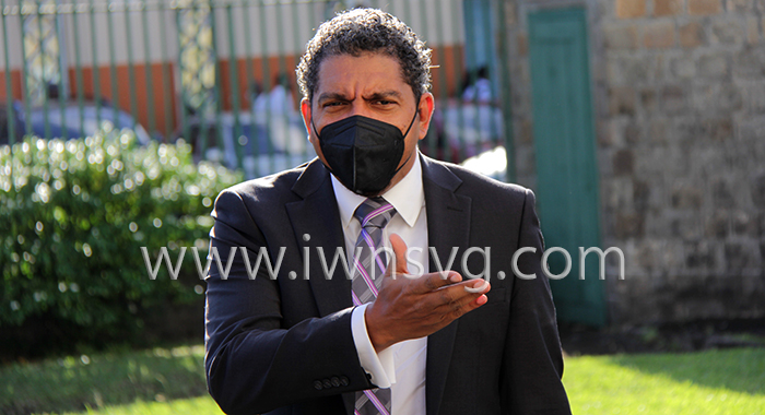 Minister of Finance Camillo Gonsalves gestures to a parliamentary colleague as he arrives at Parliament on Monday afternoon. (iWN photo)