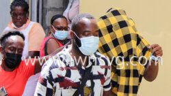 Keri Phillips uses a shirt to hide his face as he leaves the Serious Offences Court on Monday, Jan. 31, 2022. Brently Butler, who was freed of a discharge of firearm charge on Jan. 21, 2022 is at left. 