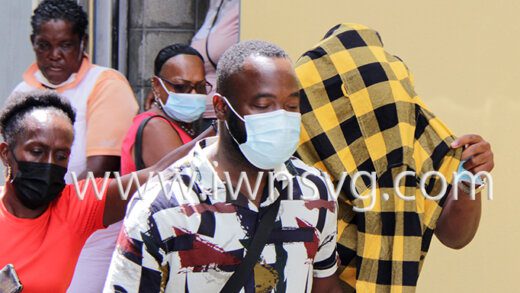 Keri Phillips uses a shirt to hide his face as he leaves the Serious Offences Court on Monday, Jan. 31, 2022. Brently Butler, who was freed of a discharge of firearm charge on Jan. 21, 2022 is at left. 
