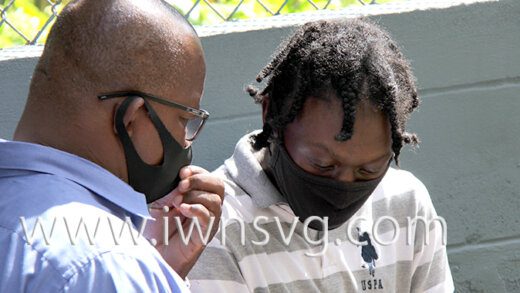 Ozem Oliver, right, speaks with an unidentified man outside the Serious Offences Court as he awaits transportation to prison on Wednesday, Jan. 19, 2022.