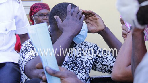 The defendant, Damian Glasgow hides his face as he awaits transportation to prison on Thursday, Feb. 10, 2022.