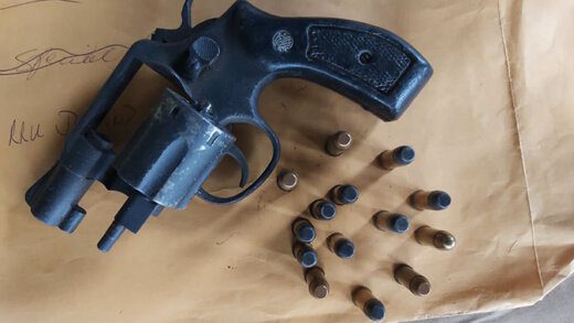 The firearm and ammunition found during the raids. 