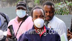 The defendant, Joloney David, centre, is escorted to court on March 9, 2022.