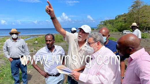 Minister of Urban Development, Senator Julian Francis, points out an area of the quarry sire (not pictured) to Prime Minister Ralph Gonsalves during a visit to Richmond on Friday, March 11, 2022. MP for North Leeward, Carlos James, is at left. 