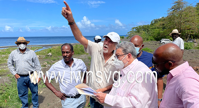 Minister of Urban Development, Senator Julian Francis, points out an area of the quarry sire (not pictured) to Prime Minister Ralph Gonsalves during a visit to Richmond on Friday, March 11, 2022. MP for North Leeward, Carlos James, is at left. 