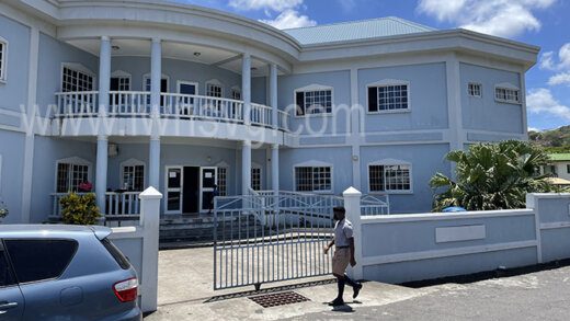 A police recruit walks past the Calliaqua Town Hall building on Wednesday, May 11, 2022. The magistrate is located on the left section of the ground floor of the building. 