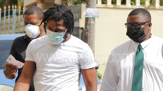 Detectives Corporal Henry Hoyte, left, and Constable 647 Roberts escort the accused, Curtley "Beenie Man" Nanton to court on Thursday, May 19, 2022.