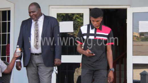 The lead investigator, Assistant Superintendent of Police, Oswin Elgin Richards, left, and the defendant, Zackrie Latham outside the Calliaqua Magistrate's Court on Wednesday, May 11, 2022.