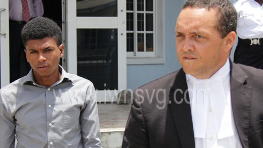 The defendant, Zackrie Latham, left, and his lawyer Grant Connell outside the Calliaqua Magistrate's Court on May 17, 2022.