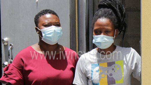 A plainclothes police officer escorts the defendant, Zepporah John, right, from the Serious Offences Court on Thursday, May 2, 2022.