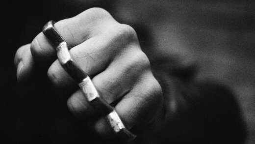 An internet photo of a hand wearing brass knuckles.