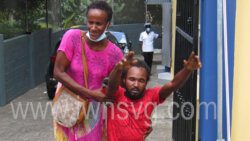 Casmore Hepburn, right, reacts outside the Serious Offences Court, on Monday, June 13, 2022 after being fined for leaving his son at home on June 5, 2022. Hepburn's girlfriend is at left.