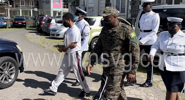 Police officers escort murder accused Veron Primus back to prison on Friday, June 24, 2022.