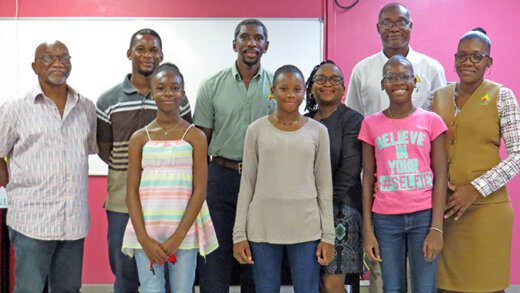 Front (from left). 2022 acholarship recipients: Mesah Salandy, Alina Gilbert and Kaela Bobb. At back (from left): Noel Jackson, general secretary of the National Workers Movement; Richard Salandy; Mr and Mrs Anthony Gilbert; Vaughn Lewis, acting chief executive officer and Kejoe Browne Etienne.