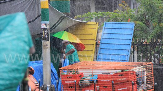 A pedestrian seeks out shelter amidst a heavy downpour in Kingstown on Tuesday, Sept. 20, 2022.