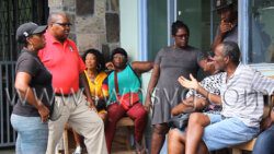 Manager of the Kingstown Fish Market, Ferique Shortte, second from left, in discussion with vendors on Thursday, Oct. 6, 2022 after they agreed revised increase fees for using the fish market. 