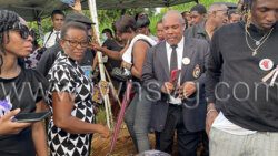 Superintendent of Police Hesran Ballantyne, who lost his daughter at Rock Gutter, stand with relatives and friends of Dorrel Bruce at his grave at the Chauncey Cemetery on Sunday, Oct. 16, 2022.