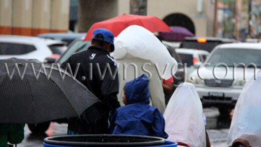 Pedestrians use umbrella and plastic bags to shelter from rain in Kingstown on Thursday, Oct. 29, 2022. More heavy rains are forecast this week. 